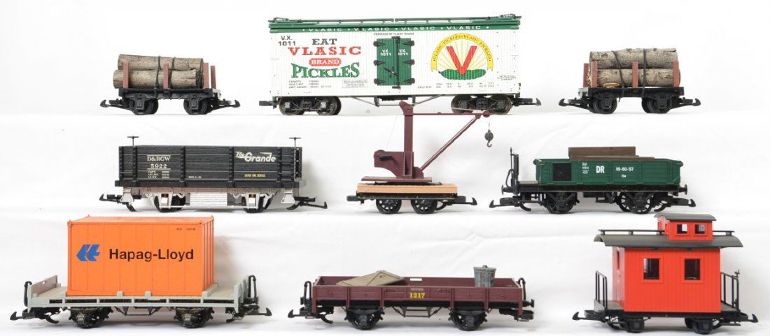 9 LGB and Aristo Craft freight cars: Modern G scale trains from LGB and Aristo Craft. Nine cars include Rio Grande gondola, DR gondola, LGB boom car,2 two axle log car, 1011 Vlasic reefer, LGB flat with Hapag-Lloyd container, bobber cabo