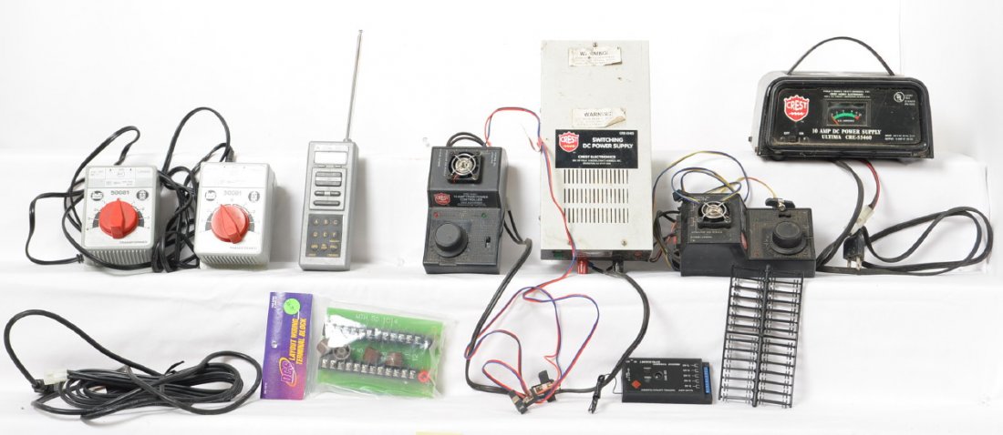 CREST and LGB G scale power supplies and controls: Modern G scale transformers and remotes from CREST and LGB. Includes two 55401 10 AMP controllers, 55460 10 AMP power supply, 55465 switching DC power supply, 55003 remote, 5475 switch controller, two