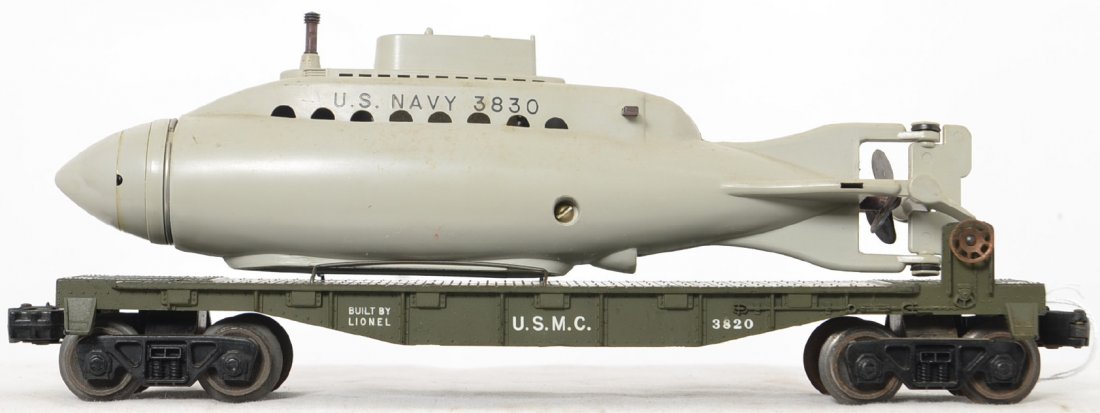 Lionel Postwar O gauge olive drab 3820 USMC submarine: Lionel Postwar O gauge olive drab 3820 USMC submarine flat car with original US Navy submarine. Flat car is in great shape with great lettering on both sides and few signs of handling but has light ru
