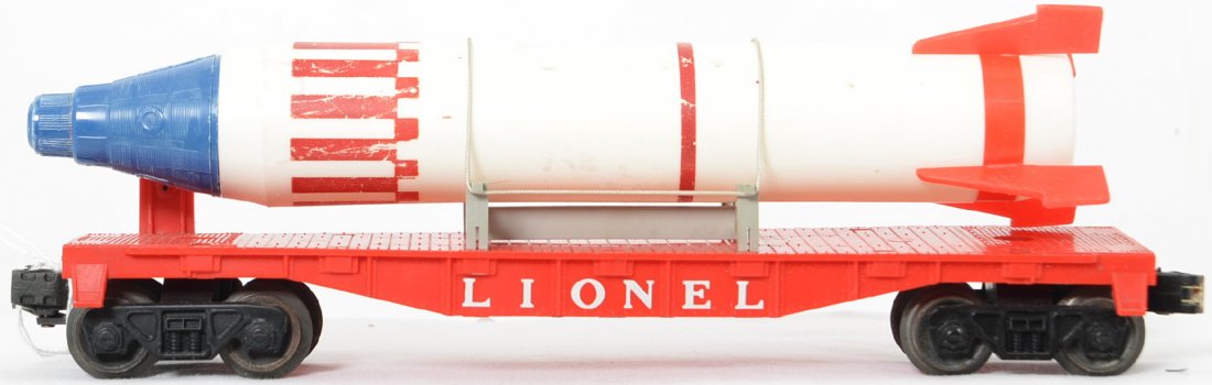 Lionel Postwar O gauge 6407 flat with a blue nosed: Lionel Postwar O gauge 6407 flat with a red nosed Mercury missile capsule. The capsule is actually a pencil sharpener and all original but has some rubs on the decoration, C6.