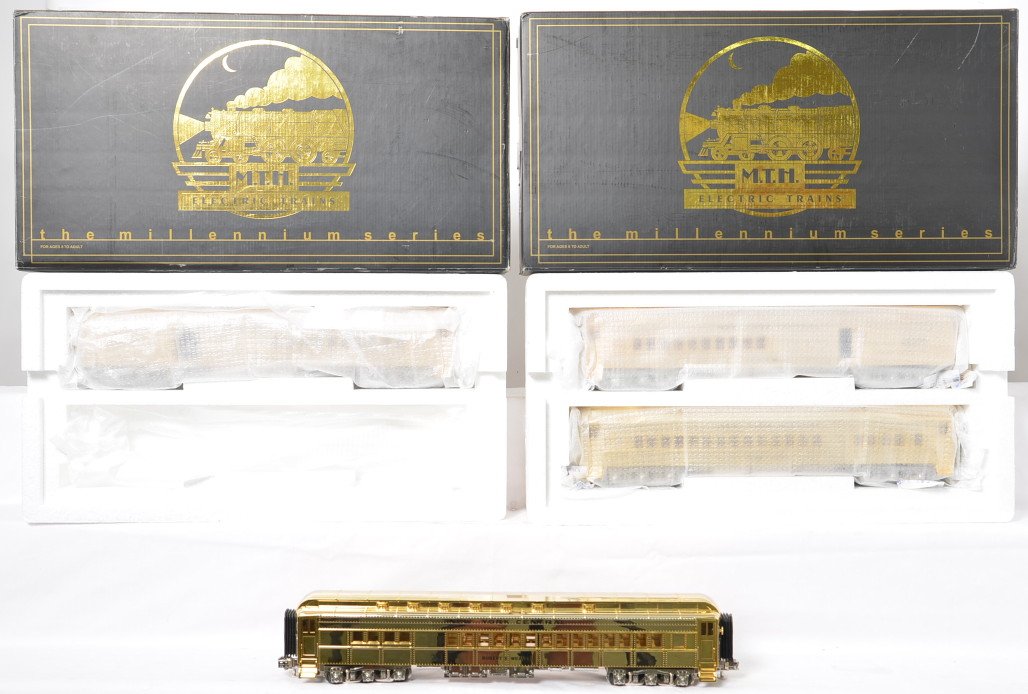 4 MTH gold Madison passenger cars 20-4129: MTH modern O gauge 20-4129 Millennium series gold plated New York Central passenger cars in OB. Cars are Robert E. Weaver and Jerome M, Williams. Two sets of these cars. One set is C7-8 with run time 