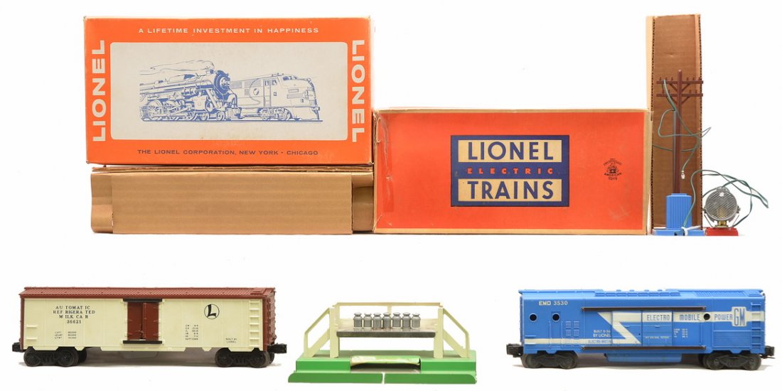 Lionel Postwar Freight Cars 3530 3662 Boxed: Lionel postwar 3530 operating generator car with searchlight and telephone pole and 3662 operating milk car, circa 1964-66 with AAR trucks, milk cans and stand both in OBs that have original cardboard