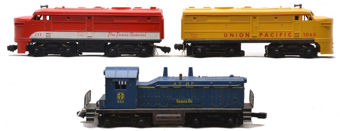 Lionel 1065 UP Alco A 211 Alco 634 SF Switcher: Lionel postwar 1065 Union Pacific Alco power A unit, 211 Texas Special Alco dummy A unit and a 634 Santa Fe NW2 switcher with a broken cab by the screw hole. The 211 has broken pilot skirt. The units