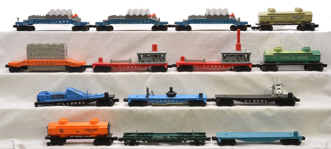 Lionel Postwar Selection of Freight Cars: Lionel postwar freight cars including; three 6544 missile firing cars, 6519 Allis Chalmers, two 3413 Mercury capsule cars, 3545 operating TV monitor car, 3410 helicopter launching car missing the heli
