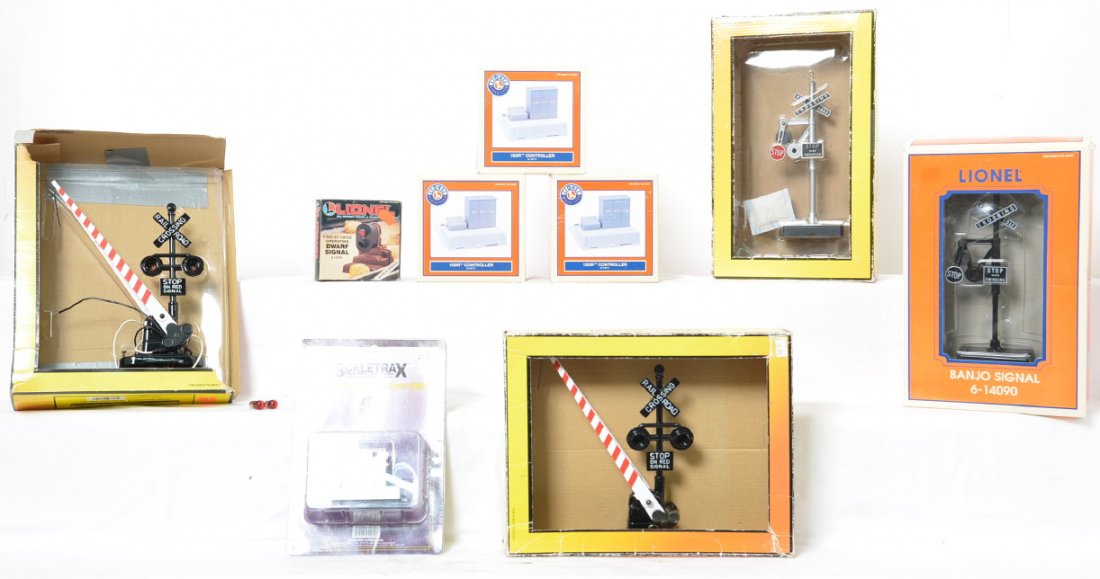 Lionel and MTH signals and IR controllers: Lionel and MTH modern O gauge signals and controllers in OBs. Includes 1093 banjo signal,two 1073 crossing gates missing bulbs, 14090 banjo signal, 12704 dwarf signal, three 14111 153IR controllers, a