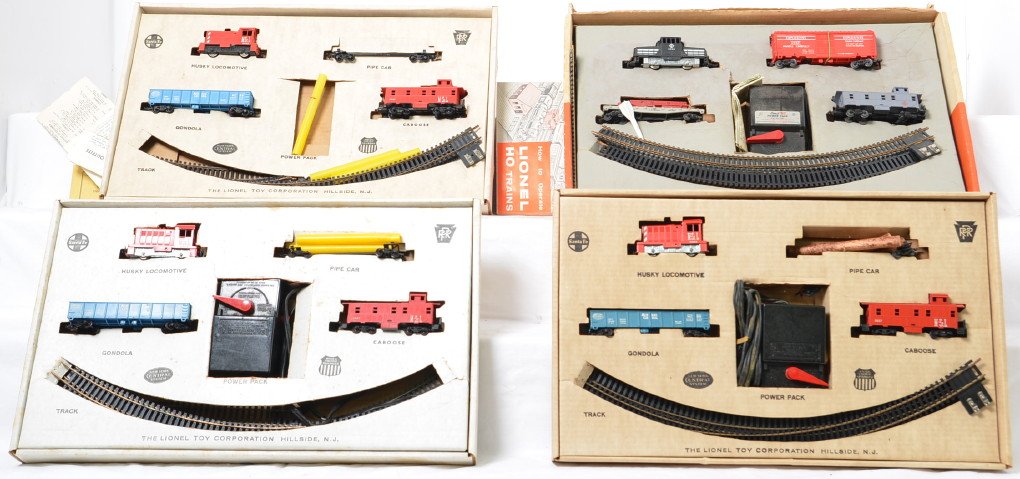 Four Lionel Postwar O gauge HO freight sets in OBs: Four Lionel Postwar O gauge HO freight sets in original boxes. There are three 14240 4 unit husky diesel freight sets and a 14013 four piece diesel switcher freight set. This is a General Condition lo