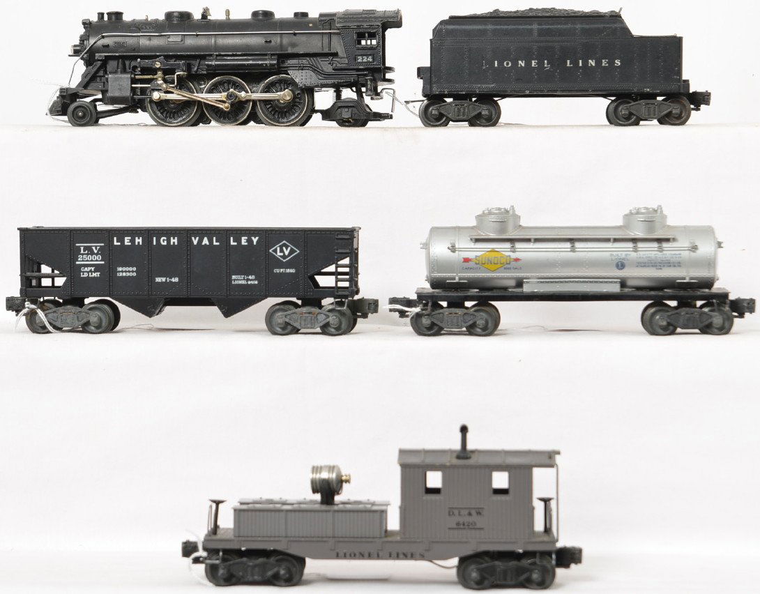 Lionel Postwar O gauge 224 2-6-2 steam locomotive with: Lionel Postwar O gauge 224 2-6-2 steam locomotive with freight cars including 6466WX tender, 6456 Lehigh Valley hopper, 6465 Sunoco tank car and 6420 D. L. & W. searchlight caboose with serif letterin