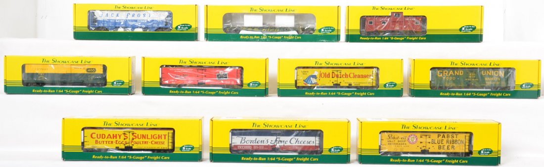 Ten Showcase Line S-Helper freight cars in OBs: Showcase Line S-Helper freight cars in original boxes to include 00578 C&NW boxcar, 00560 Reading flat car, 00602 Rock Island caboose, 00972 3 bay hopper 2002 Christmas car and six reefers to include 