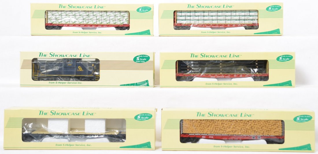 Six Showcase Line S-Helper freight cars in OBs: Six Showcase Line S-Helper freight cars in original boxes to include 02200 Chesapeake and Ohio caboose, 00263-5 Boston and Maine flat car, 00302 MEC pulpwood load, 00331 Santa Fe BC-WL load, 00333 Gre
