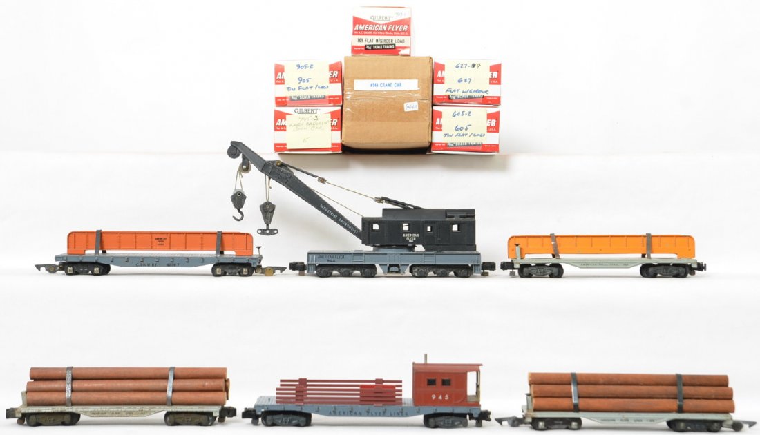 American Flyer postwar S gauge 605 905 909 944 945: American Flyer postwar S gauge rolling stock to include 605 & 905 tin flats with log loads, 909 & 42597 flat cars with girder loads, 944 work crane and 945 work caboose in reproduction boxes, C6.
