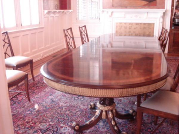 Mahogany Dining Room Table with 3 leaves: Dining Room Table, 3 leaves, mahogany, oval with wood inlay, carved wood and gold-painted aprons, three carved pedestals, each with four carved legs, gold rope and tassel and leaf décor, 167" x 54", 