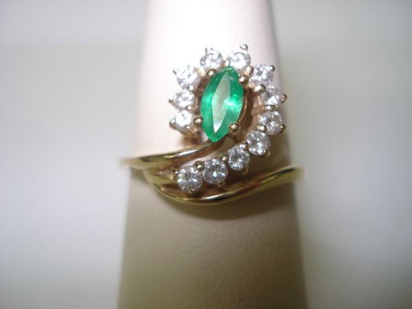 Lady's Emerald/Diamond Ring: Lady's Emerald/Diamond Ring, marquise faceted emerald weighs approx. 0.22 cts., full cut diamonds total approx. 1/3 ct., VS clarity, near colorless, 14K yg, ring size 7, 2 dwt