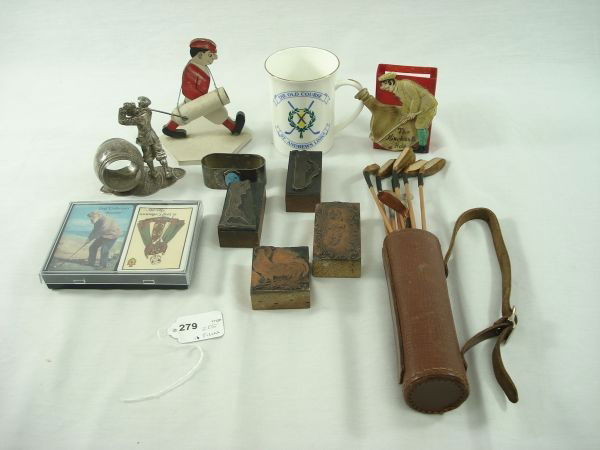 Assorted Golf Items: Assorted Golf Items: Includes 2 napkin rings, playing cards, mug, 19th Hole cigarette holder, wooden toothpick holder, mini clubs & bag, 4 stamp blocks (2 are not golf realted)