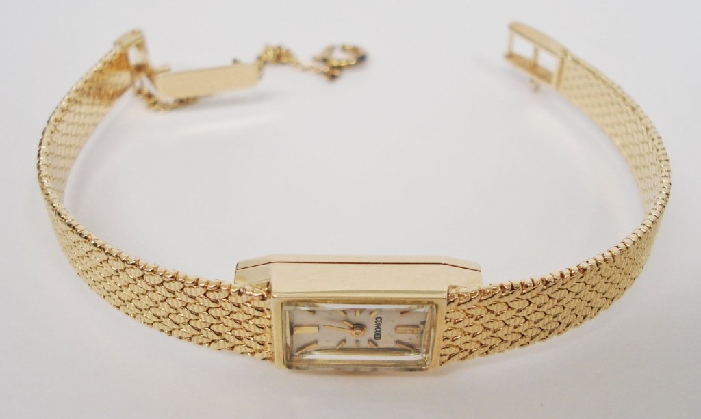 Lady's 14K Concord Watch: Lady's 14K Yellow Gold Concord Watch, 21 jewel movement, L. 6", runs, safety chain, 15.28 dwt