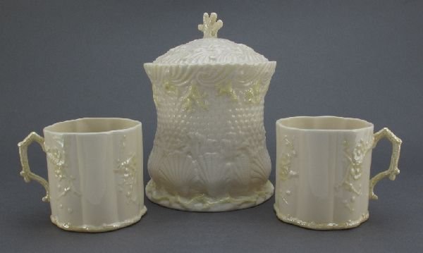 3 Pcs Belleek China: Biscuit Jar and 2 Mugs: 3 Pieces Belleek Fine Parian China: Biscuit Jar with Lid, Yellow Cobb lustre finish, fifth (green) mark (1955-65); 2 Mugs with stem handles, Yellow Cobb lustre finish, sixth (green) mark (1965-81); al
