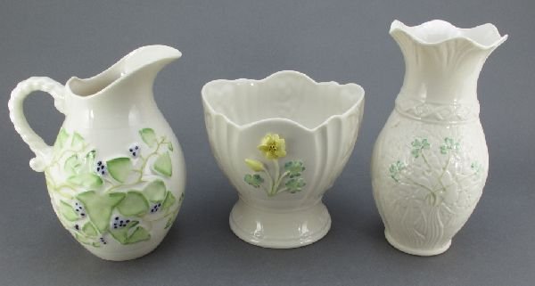 3 Pieces Belleek China: Vase, Pitcher, Flower Pot: 3 Pieces Belleek Fine Parian China: Vase with Green Shamrocks on top of shamrock design, marked "Blarney Woollen Mills First Edition", H.7"; Flower Pot with applied shamrocks and yellow flowers, marke