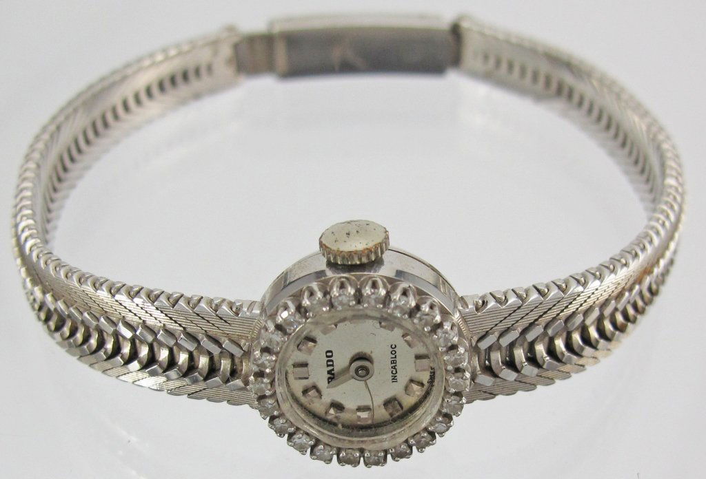 18K White Gold Diamond Rado Lady's Watch: Lady's Wristwatch by Rado, signed on dial and jeweled movement, approx. 1/4 ct diamonds, 18K white gold case, L. 7.5", case dia. 15mm, 17 dwt, runs, crystal missing, fracture on dial, minute hand miss