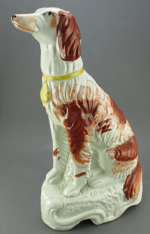 19th C Staffordshire Afghan Hound: 19th C Staffordshire depicting a Seated Red and White Afghan Hound, on white base, hairline fracture on back and under chin appears to be done in firing, possible repair on ear, H.10-7/8"