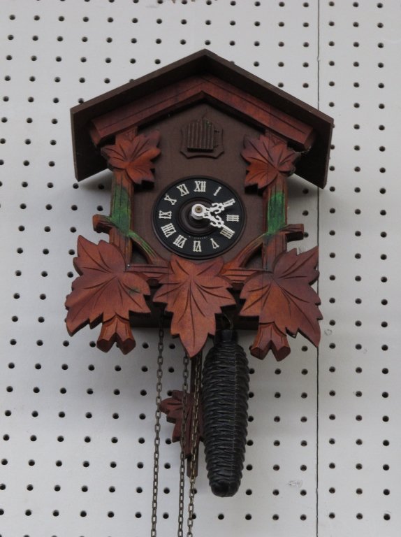 German 2-Weight Cuckoo Wall Clock: German 2-Weight Cuckoo Wall Clock, burnt red color, appears to run but does not chime, headpiece missing, H. 12-1/2"