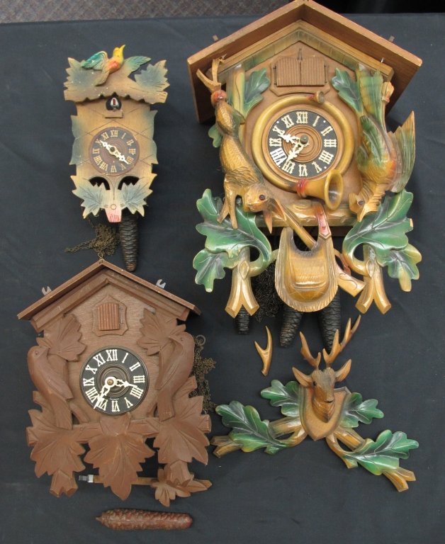 3 German Cuckoo Clocks Not Running: 3 German Cuckoo Clocks Not Running: German 3-weight Cuckoo Clock With Hunting Motif, one deer antler broken, one deer antler repaired on headpiece, height including headpiece 18"; German 2-weight Cuck
