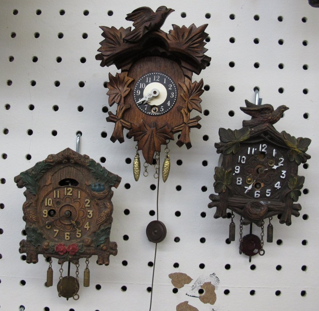3 Small Cuckoo Style Clocks All Running: 3 Small Cuckoo Style Clocks All Running: Bird and Leaf Motif clock, H. 5-1/2" not including decorative weights; Colorful Bird and Leaf Motif clock, H. 4-1/2" not including decorative weights; House Mo