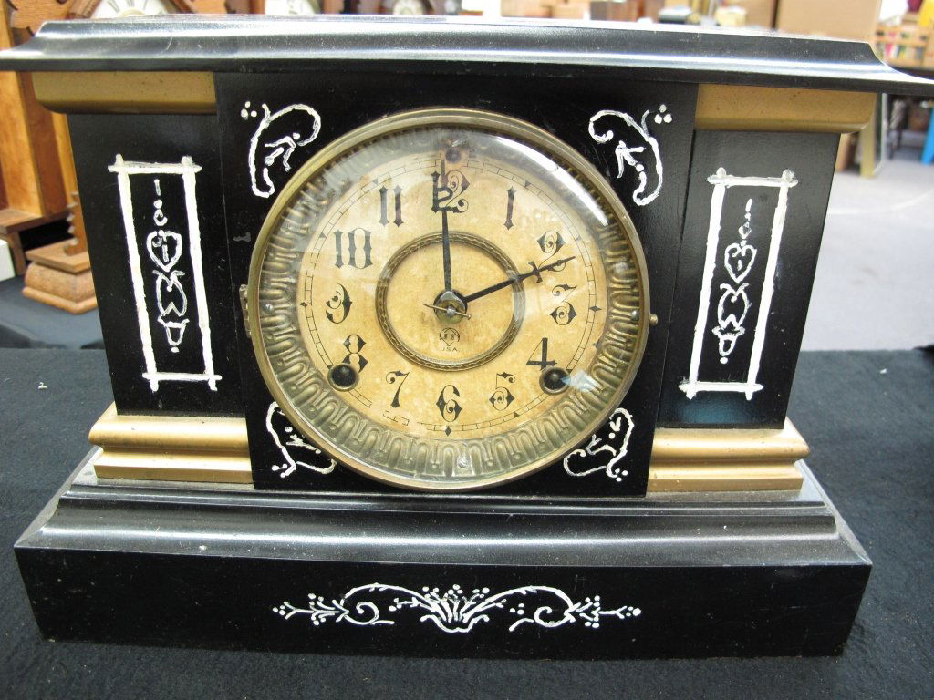 Black Mantel Clock by Seth Thomas: Black Mantel Clock by Seth Thomas, metal body, running, chiming, some hand painting on front, H. 9-7/8", W. 14", D. 5-1/2", Dial 5-1/2", no key