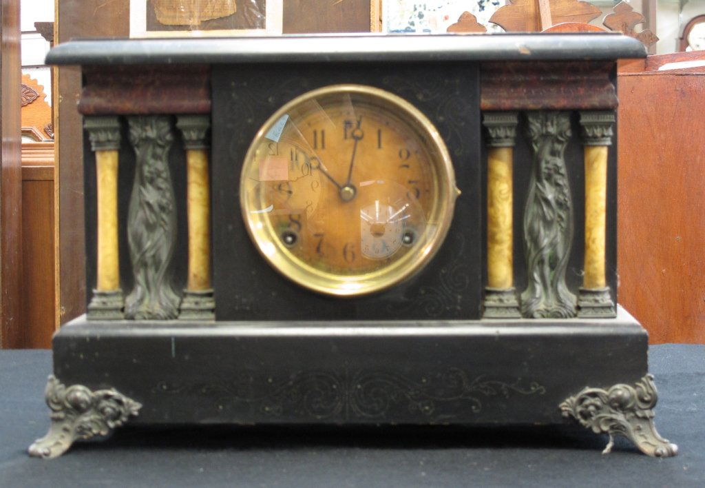 Black Mantle Clock by Sessions: Black Mantle Clock by Sessions, running, chiming, glass is loose, H. 11", W. 15-1/2", D. 6-5/8", Dial 5"