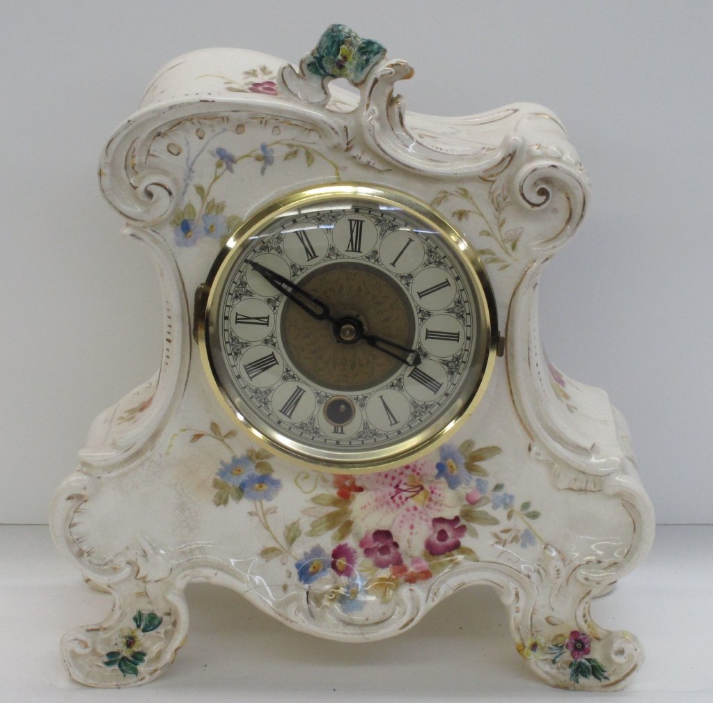 Early German Porcelain Clock: Early German Porcelain Clock, newer German works, running, H. 10", W. 9", D. 4-1/2", Dial 4-1/4", repair to right front leg (see pictures)