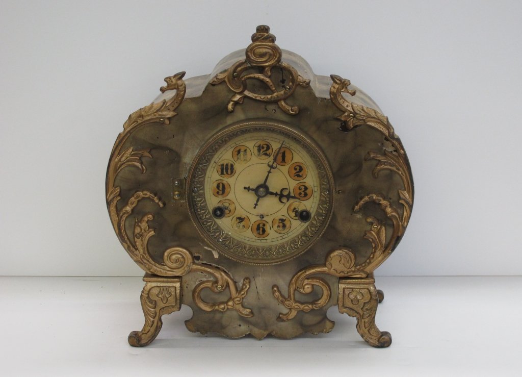 Mantel Clock by New Haven Cast Front and Base: Mantel Clock by New Haven Cast Front and Base, metal body, running, chiming, 8-day, H. 11-5/8", W. 10-3/4", D. 4-3/4", Dial 5"