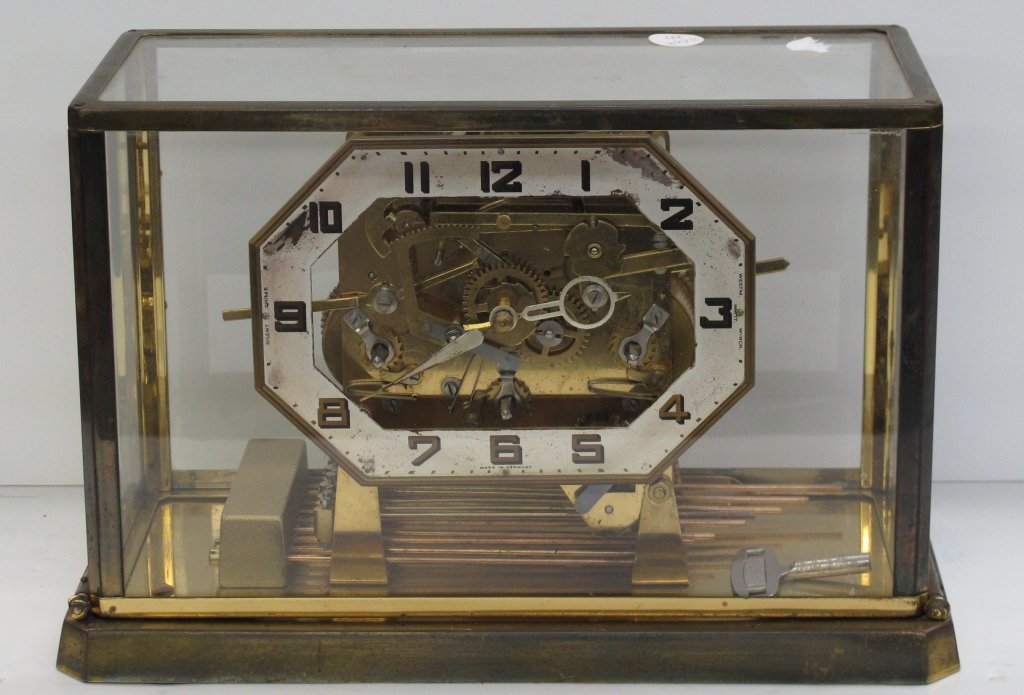 Brass and Glass German Case Clock Key Wind: Brass and Glass German Case Clock Key Wind, chimes selector for 3 different chimes, open escapement, dial is marked "Made in Germany", movement is marked "Cuckoo Clock Mfg. Company Inc.", glass case i