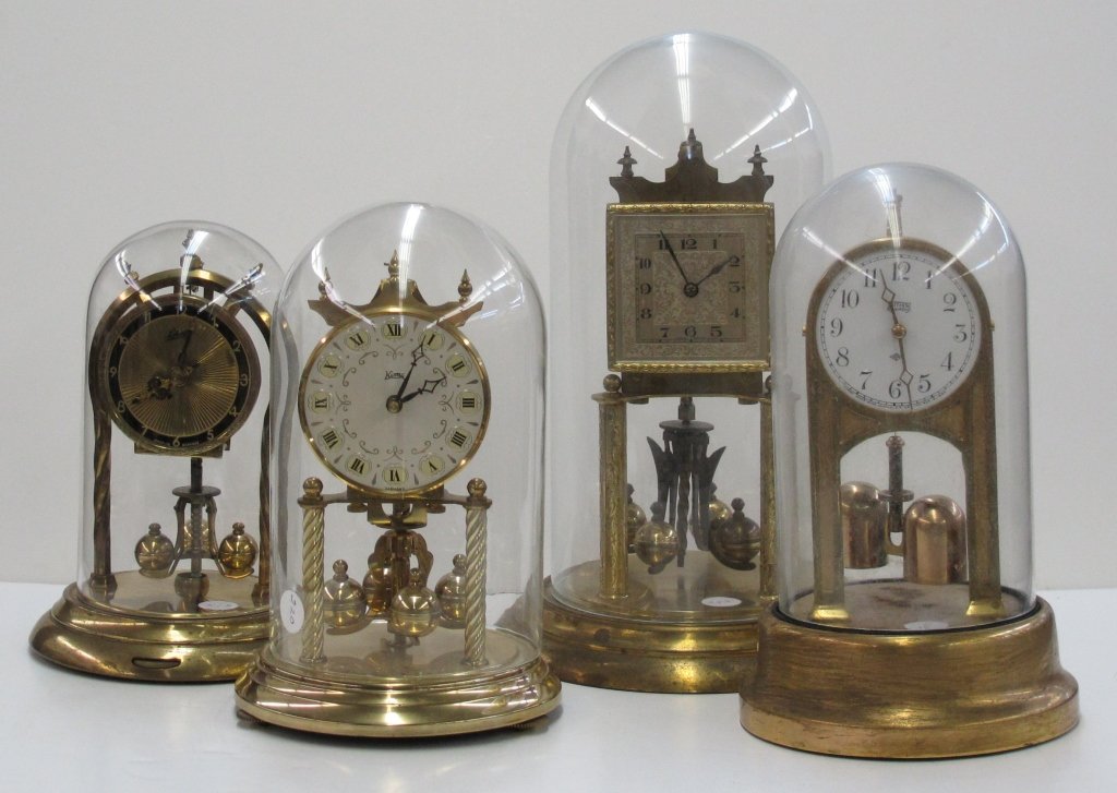 4 Anniversary Clocks: 4 Anniversary Clocks, all appear to have no broken or missing pieces: Schatz, glass globe, H. 8-1/2"; Koma, glass globe, H. 8-1/2"; K&S Germany, glass globe, H. 10"; Tiffany River-Wind, glass globe, H