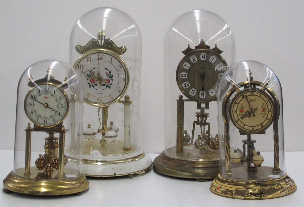 4 Anniversary Clocks: 4 Anniversary Clocks, all appear to have no missing or broken parts: Kundo, plastic globe, H. 8-3/4"; Montgomery Ward, replacement glass top by Corning, H. 11"; Haller, replacement glass globe by Corn