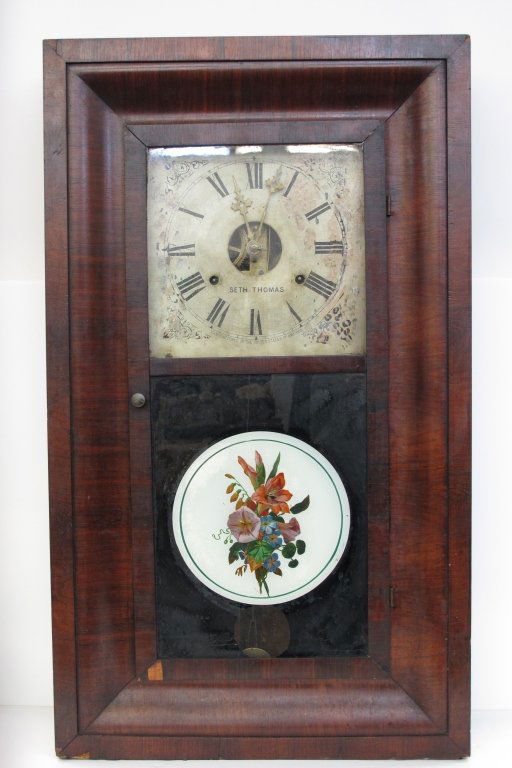 Weighted Ogee Clock by Seth Thomas 8-Day: Weighted Ogee Clock by Seth Thomas 8-Day, tin dial, H. 29-1/2", W. 17-1/4", death 4-1/2", Dial 9-1/4", movement kicks but won't stay running, chimes on the hour