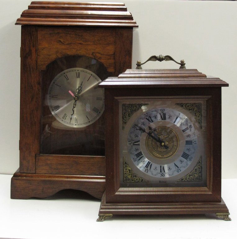 2 Battery-Operated Shelf Clocks: 2 Battery-Operated Shelf Clocks: Quartz Shelf Clock, door needs repair, running, H. 19-1/2" D. 7-3/4"; USAF Quartz Case Clock, Bulova movement, running, chiming, H. 14-1/2", D. 6"
