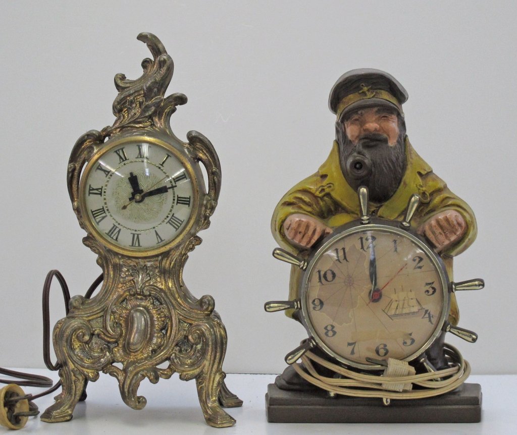 2 Novelty Electric Clocks: 2 Novelty Electric Clocks, running; Ornamental Brass Electric Clock by Lanshire, running, H. 11-1/2"; electric novelty sailor clock by Mastercrafters, running, light in beard glows