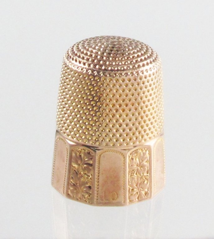 14K Gold Thimble Floral Engraving: 14K Yellow Gold Thimble with floral engraving around bottom, size 10, inside is marked 14K over a hallmark which is an open arrow with the letter C inside, 3.30dwt