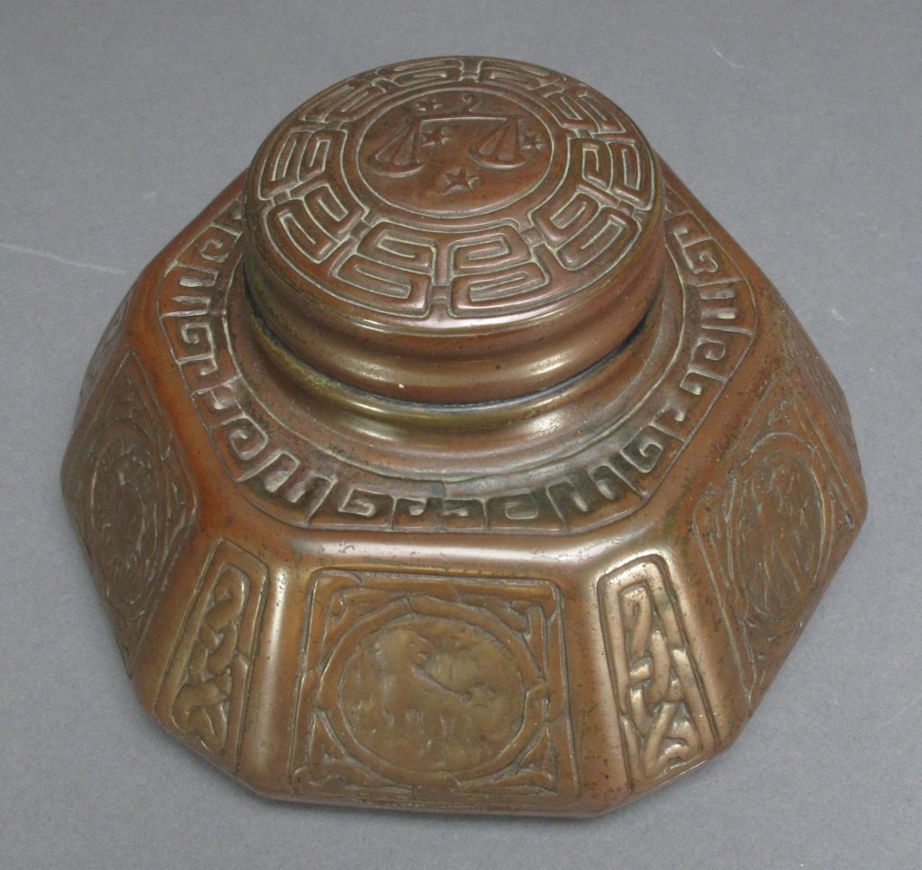 Tiffany Studios Bronze Zodiak Inkwell Early 20th C: Tiffany Studios Bronze Zodiak Inkwell, early 20th century, hexagonal shape, hinged lid, original heavy glass ink pot, marked on bottom: "Tiffany Studios / New York / 1072", Dia. 6-3/4", H. 3-1/2"