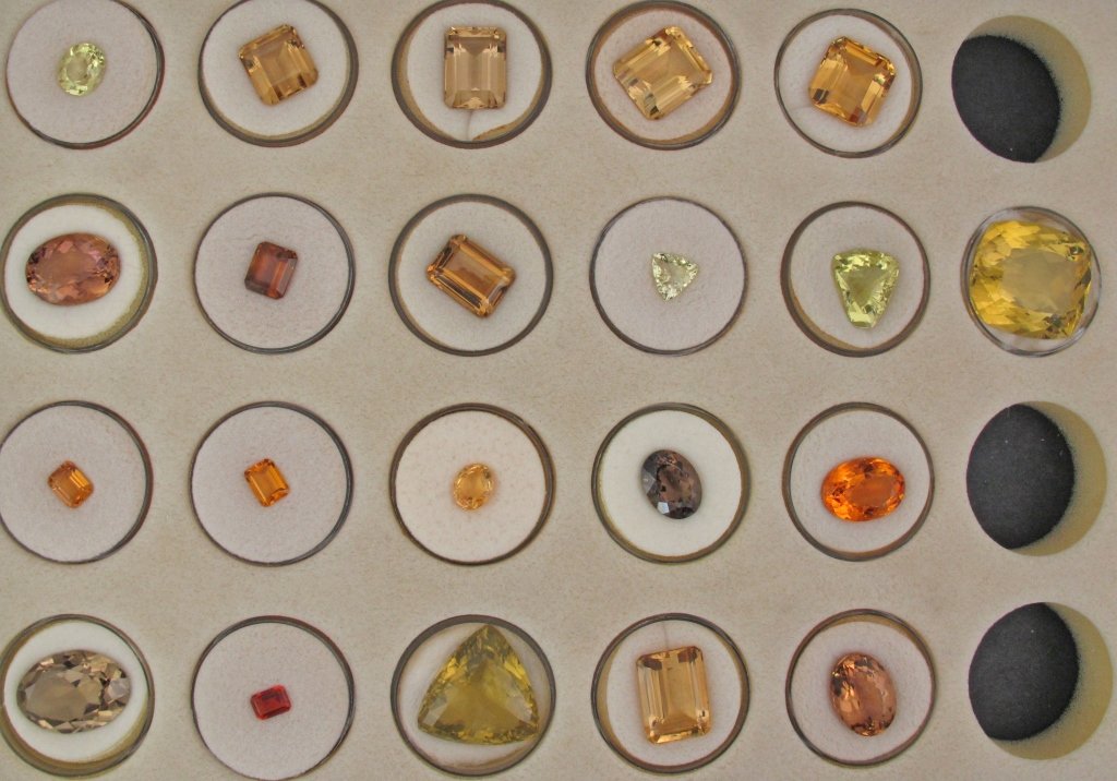 21 Faceted Quartz Gems, Citrines, Smoky and Lemon: 21 Faceted Quartz Gems, Citrines, Smoky and Lemon, various shapes and sizes, largest weighs 75 cts., includes one from Russia, 13 from Brazil, 2 from Madagascar, and 1 prasiolite from Africa