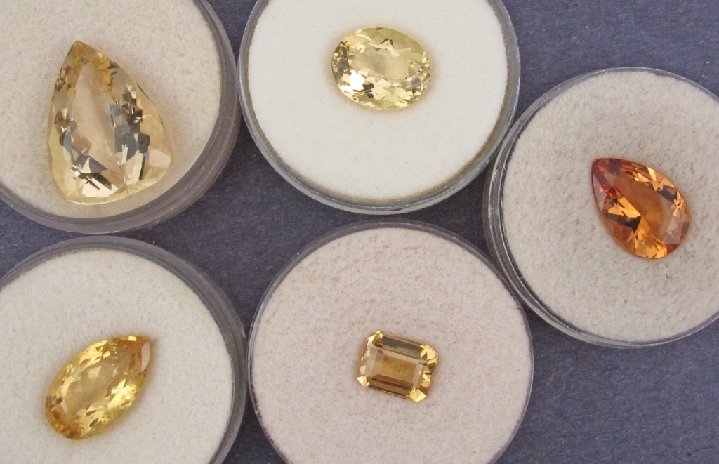 Faceted Gems: 4 Golden Beryl and 1 Heliodor: Faceted Gems: 4 Golden Beryl totaling 30.15 cts (larges is 17 cts.) (2 from Nambia); 1 Heliodor Oval weighing 5.21 cts from Russia