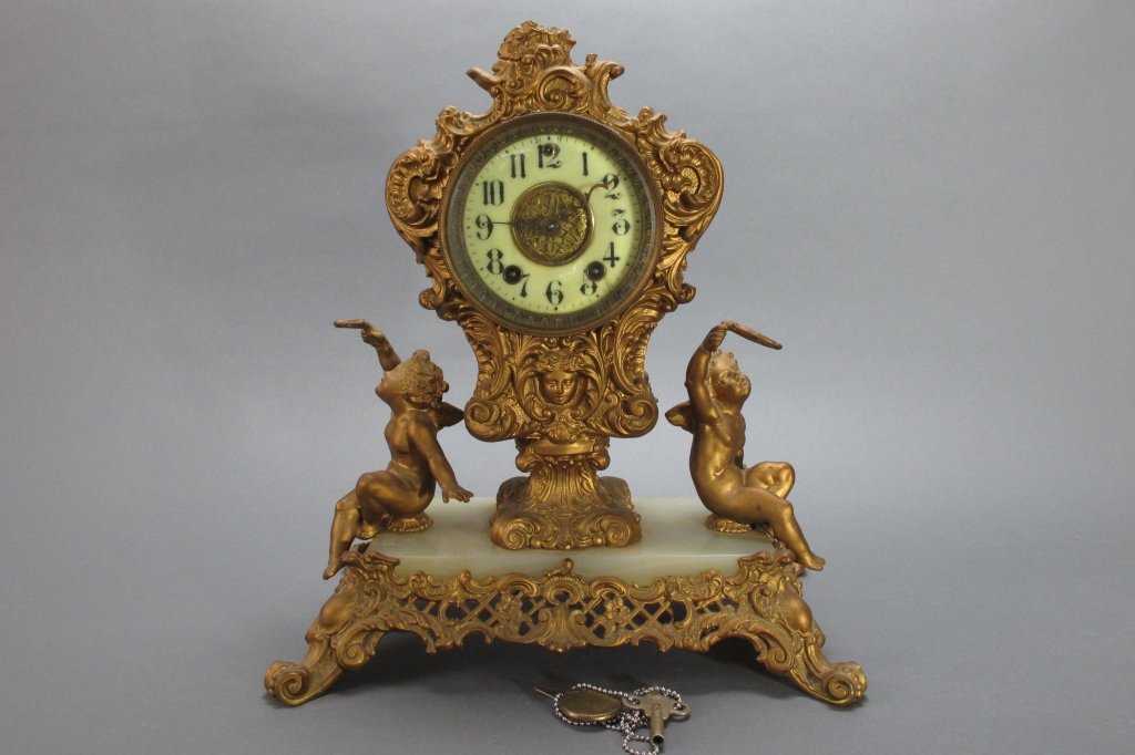 Gilbert Art Nouveau Table Clock: Gilbert Art Nouveau Gilt and Marble Table Clock, porcelain dial, ornate cherub design, ca 1900, w/ key and pendulum, pat'd 1896, H.