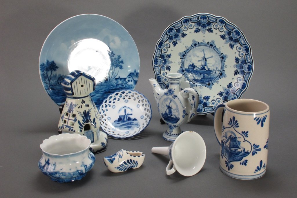 9 Pcs Blue Delft Pottery: 9 Pcs Delft Pottery, 2 plates, shoe, funnel, pitcher, mug, windmill, 2 bowls: Plate, Made in Germany, Dia. 9-1/2"; Plate, Orange Line Rotterdam, Made in Holland, Dia. 9-1/2"; Shoe, L. 3-1/4"; Orange L