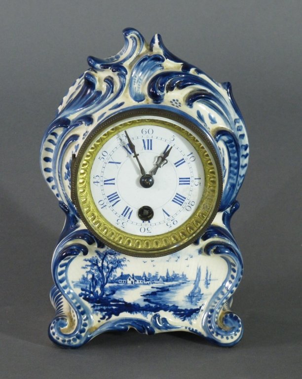 Blue and White Delft Porcelain Shelf Clock: Blue and White Delft Porcelain Shelf Clock, porcelain face with dual Roman/Arabic numerical face, movement kicks but running condition cannot be guaranteed, key wind movement, no key, H. 8-1/2", W. 4-