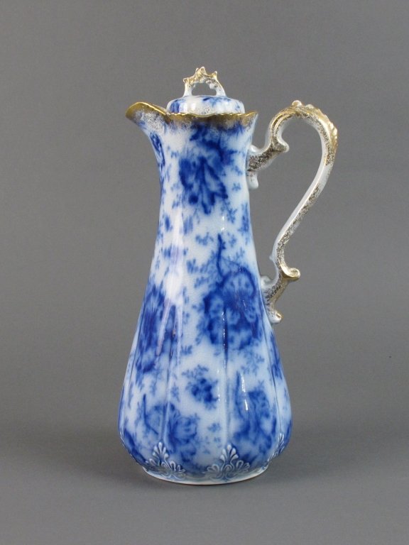 Flow Blue Chocolate Pot: Flow Blue Chocolate Pot with gilt edges and handle and cover, pansy design, crazing throughout. H. 11"