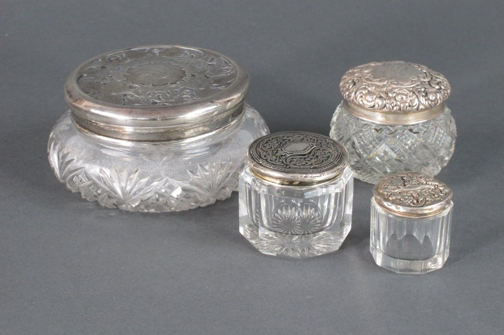 4 Pcs Sterling and Glass Dresser Jars: 4 Pcs Sterling and Glass Dresser Jars: Sterling and Cut Glass Dresser Jar by Foster and Bailey / Theodore W. Foster, some dents in fitted sterling lid, monogrammed, H. 2", Dia. 4".; Sterling and Cut G