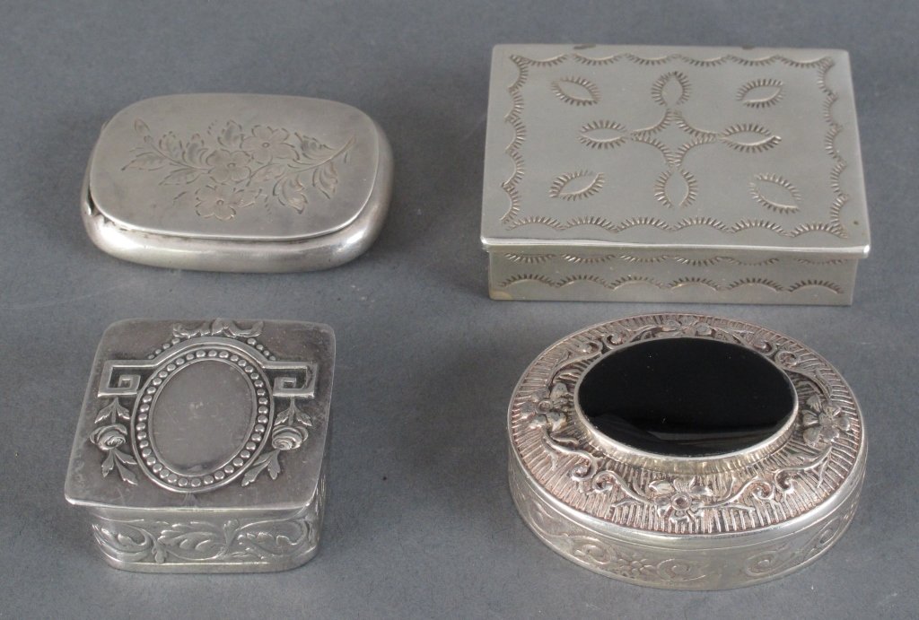 4 Sterling Silver Snuff Boxes: 4 Sterling Silver Pill / Snuff Boxes: 1-1/4" x 1-1/4" square pill box with hinged cover, decorated with vine and floral in relief; 1-7/8" x 1-1/2" Oval Form pill box with hinged cover, scroll and flor