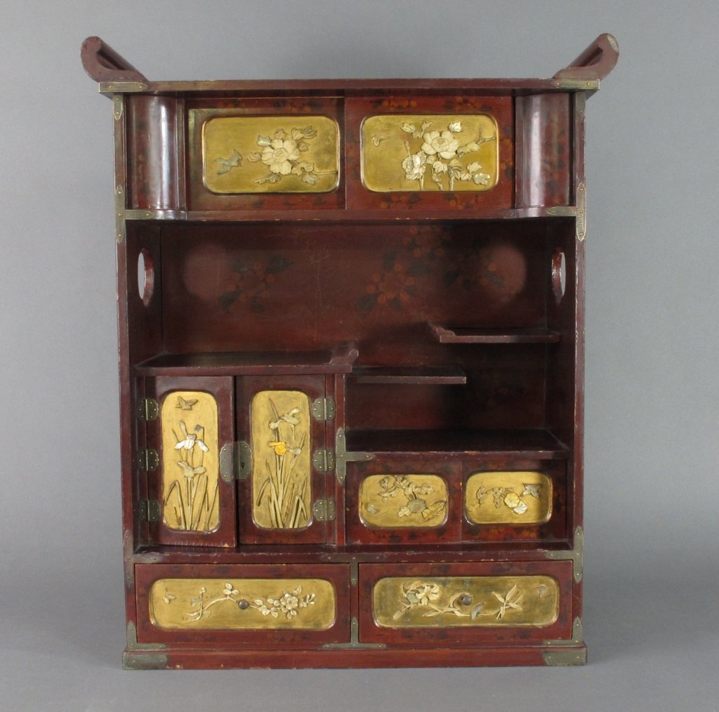 Japanese Lacquered Cabinet: Japanese Lacquered Cabinet, late 19th / early 20th century, shelves, doors and sliding panels decorated with applied bone, abalone, and gilt. Gilt has been touched up in some places, some pieces repla