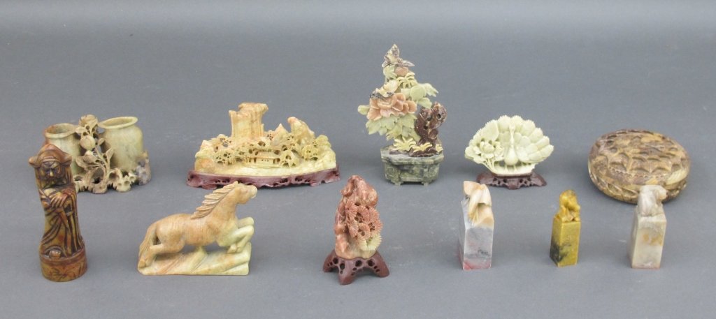 Lot of 11 Soapstone Carvings: Lot of 11 Soapstone Carvings, 3 are stamps; one is intricately carved scene with mountains, temple; one is a round box with cover; others, highest is 6"