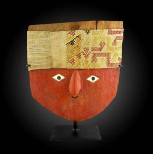 Huge Pre-Columbian Chancay Wooden Mummy Mask: Chancay Wooden Mummy mask from Peru, ca. 1000-1425 A.D. A painted wood plank mask with small painted white diamond shape eyes, black pupils. Attached textile headdress over the forehead. Custom metal