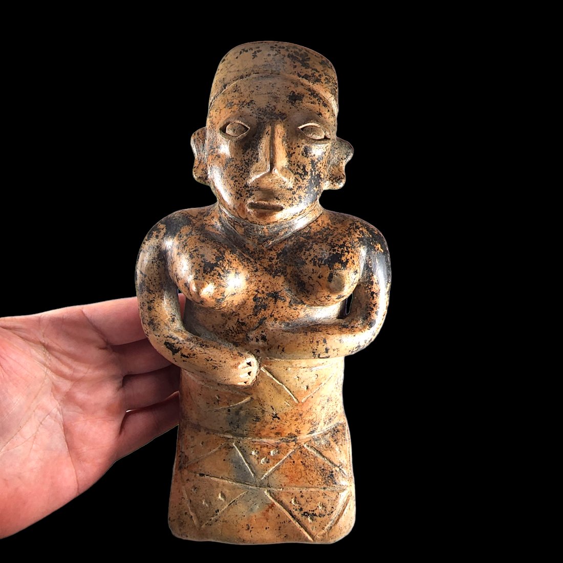 Pre-Columbian Jalisco Ameca kneeling figure: A fantastic Pre-Columbian Jalisco Ameca style figure from West Mexico, ca. 300 BCE-300 CE. Kneeling female figure wearing a skirt and headdress, arms held to her stomach. Lovely manganese deposits and