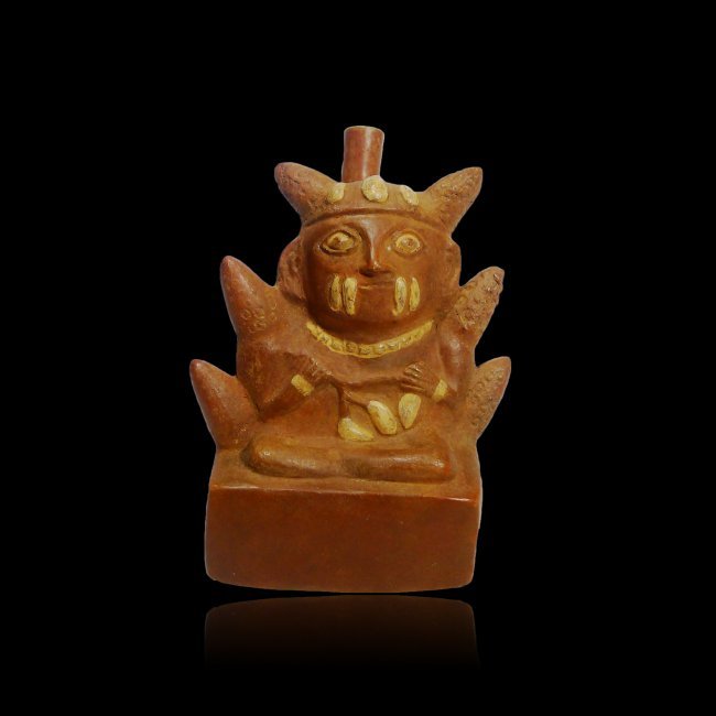 Pre-columbian Pre-columbian Chimu Corn god Vessel: Pre-columbian Chimu Corn god Vessel from Peru, ca. 1100 – 1450 AD. Rare orangware type with a seated Maiz god surrounded by maiz ears and holding a Tumbo Plant Vine. The box form of this vessel serv
